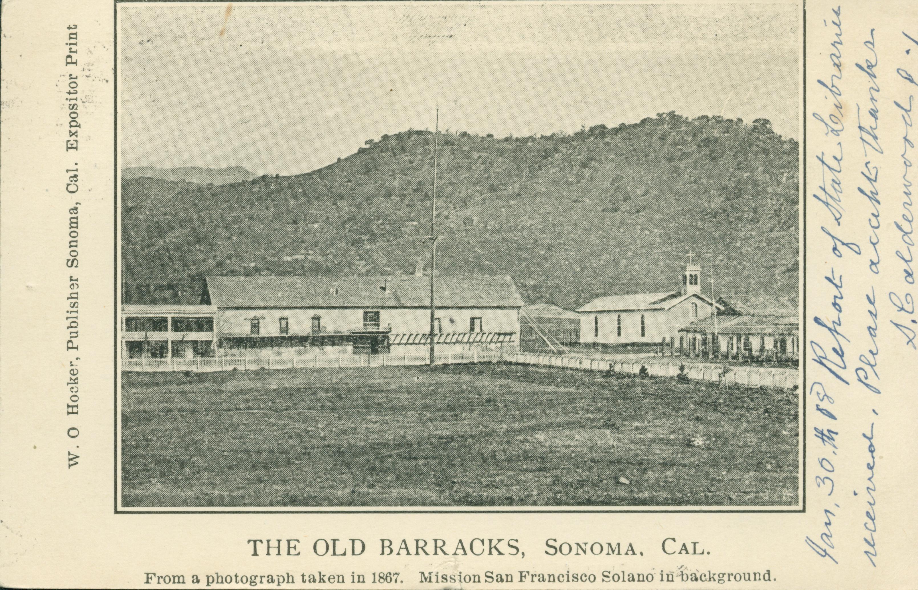 Shows the barracks overlooking a pasture with the mission in the background